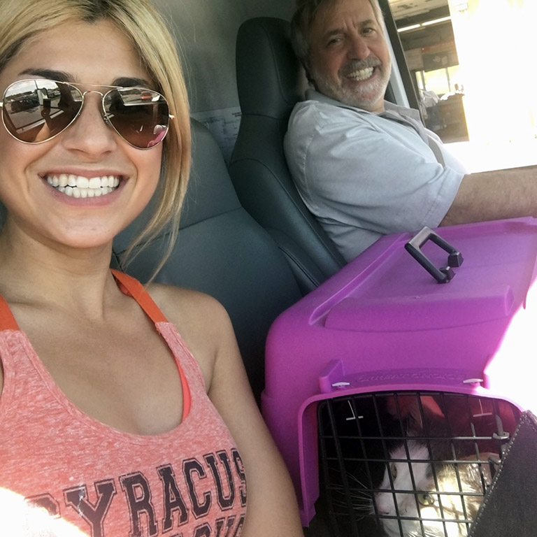 Alexa and her cat in the cab of a U-Haul