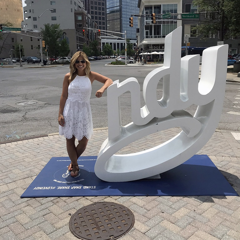 Alexa Green stands by the Indy sign in downtown Indianapolis
