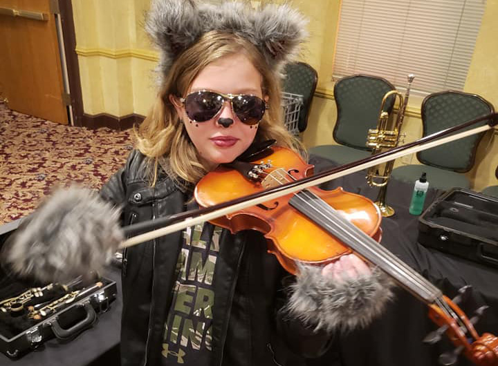 Girl playing violin in costume