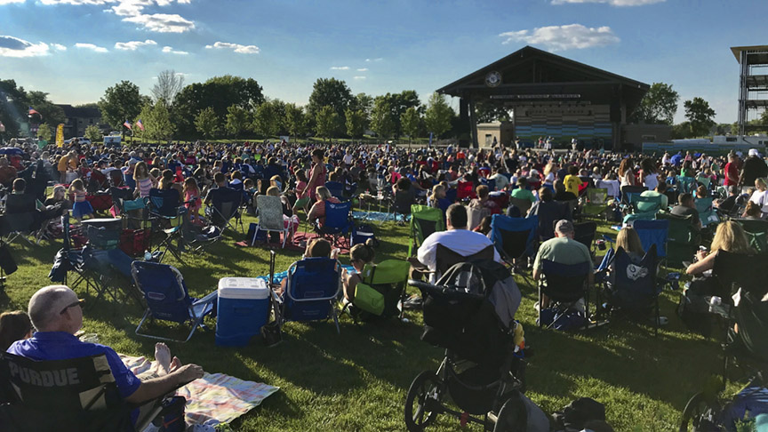 A large crowd watches a concert outdoors at the Nickel Plate Amphitheater in Fishers