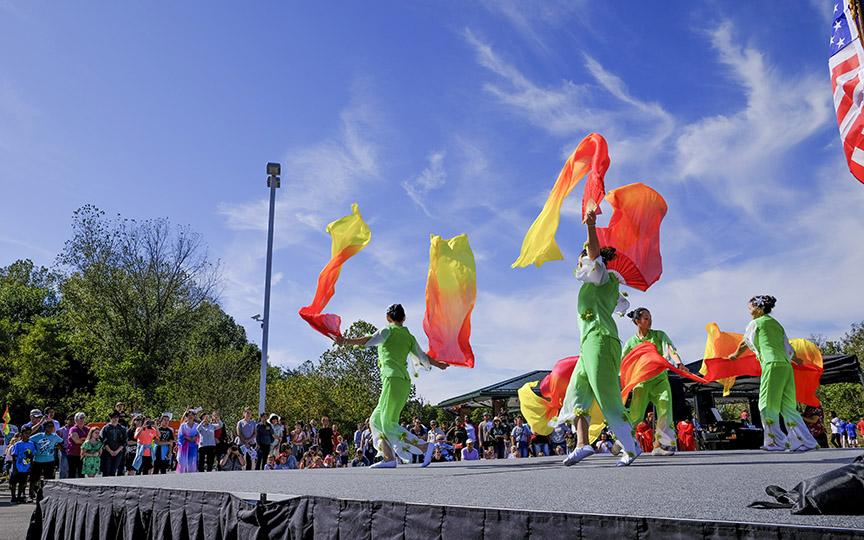 Colorful dancers on an outdoor stage at the Plainfield International Festival