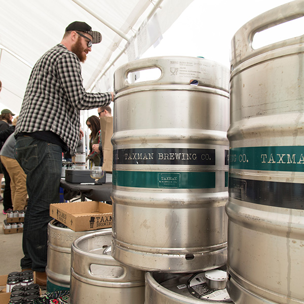 Man serving beer in Taxman Brewery keg tent at beer fistival