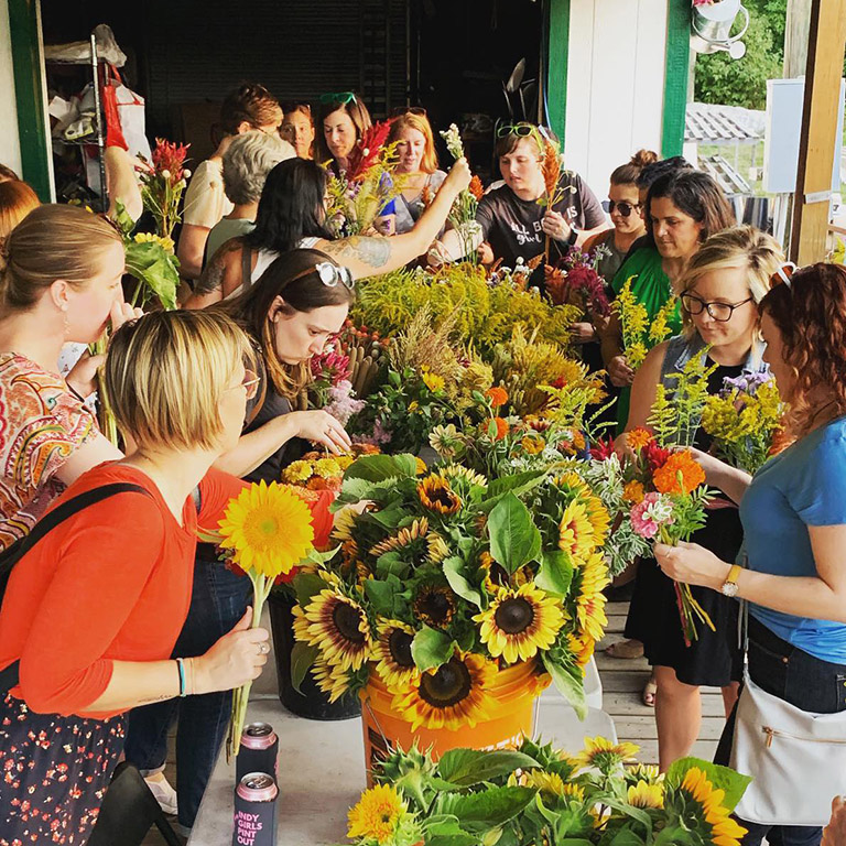 Women creating flower bouquets at Indy Urban Acres