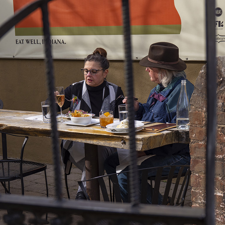 A couple eats outdoors at Bluebeard in Fletcher Place