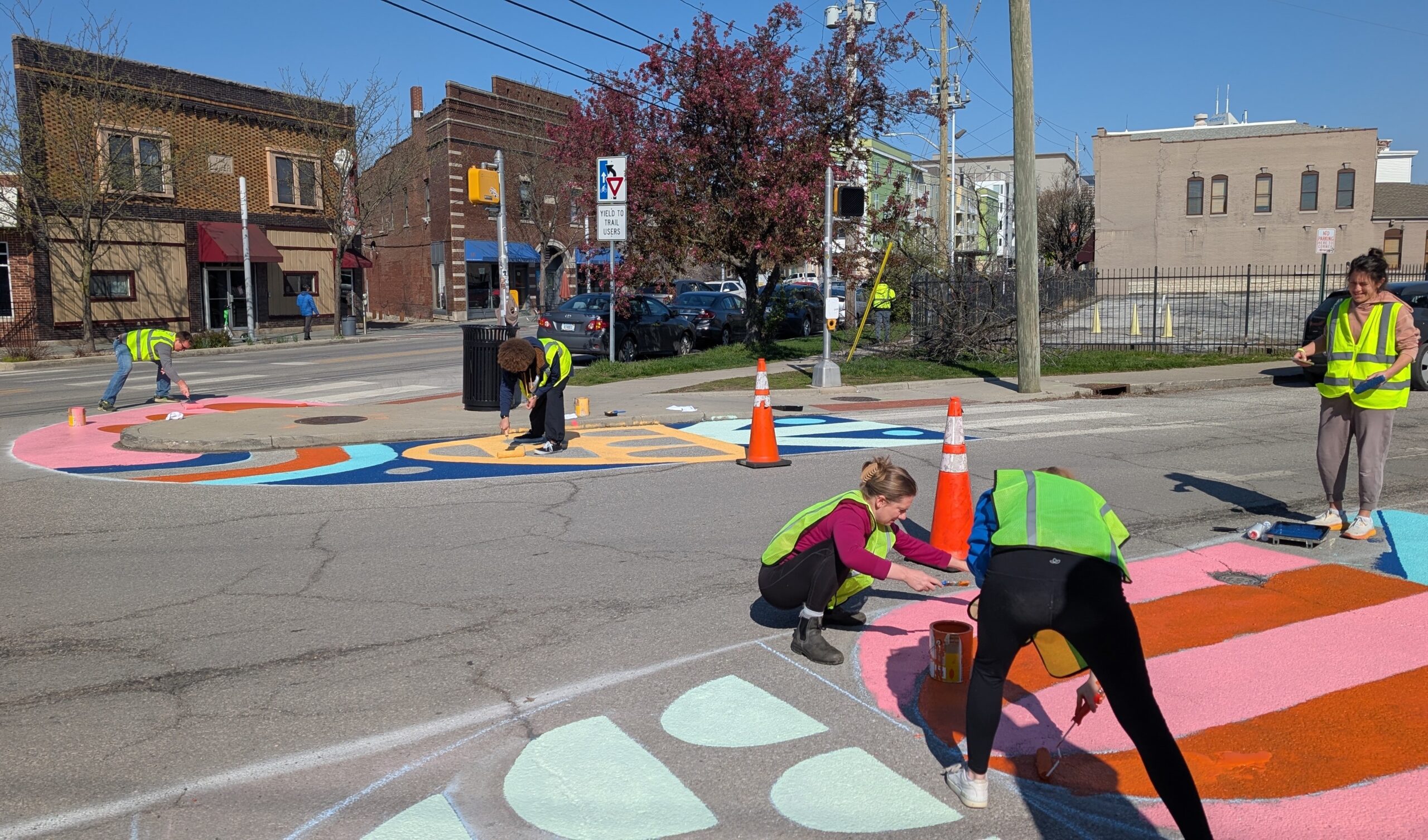Tactical Urbanism Project People painting the street to improve intersection safety and beauty