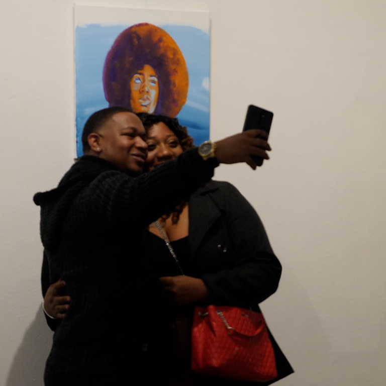 People taking a selfie at the 1000 Words art gallery