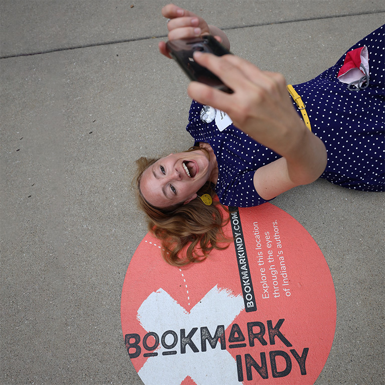 Person taking a photo at a Bookmark Indy location