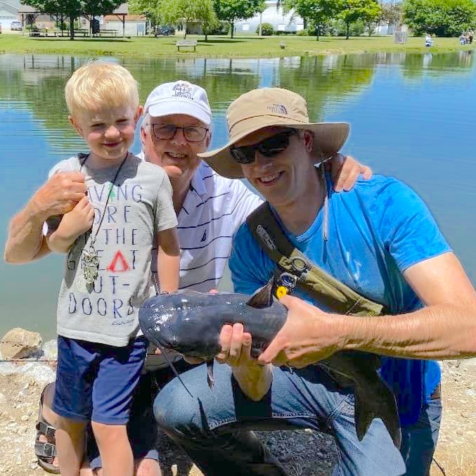 Rob and his family holding up a catfish they caught