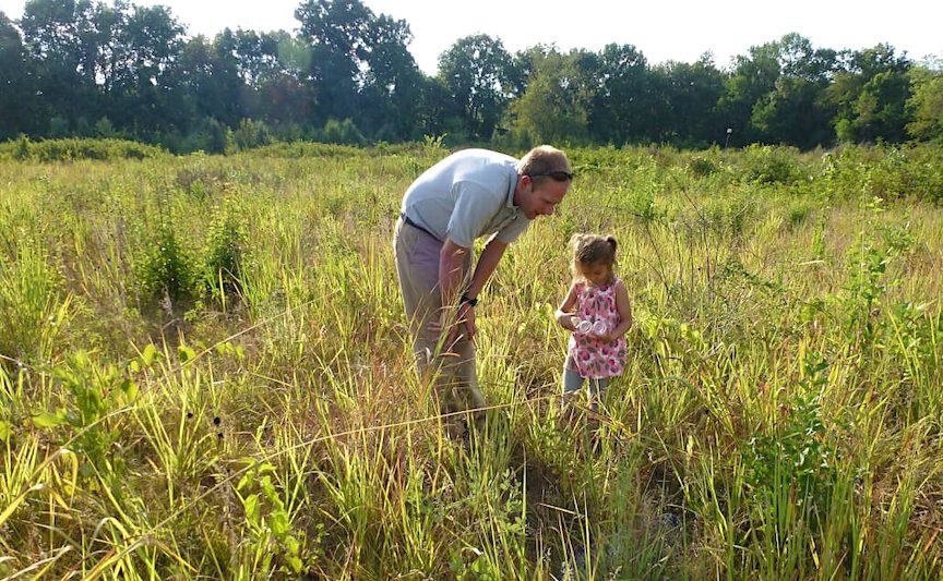 Father playing in a nature park with his daughter
