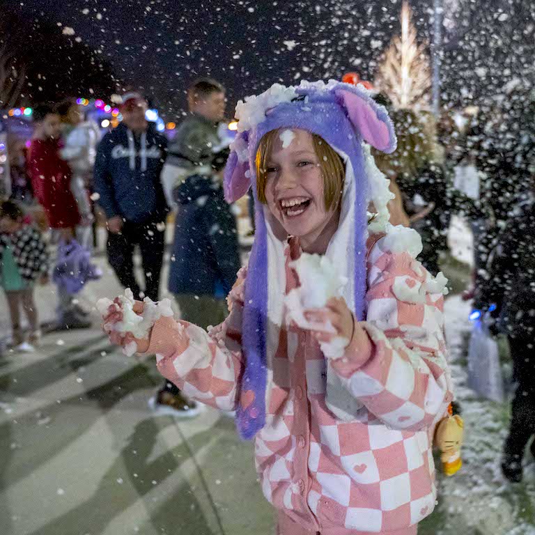 Child in the snow at Lawrence Christmas Winterfest
