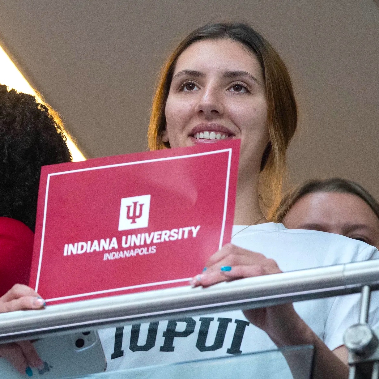 IUPUI student raising a sign that reads Indiana University Indianapolis