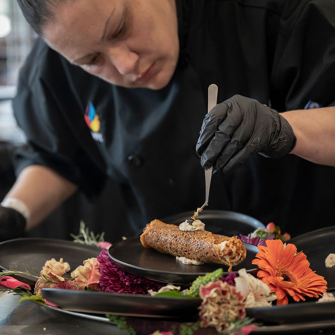 Chef Putting the Finishing Touches on Their Dish in the World Food Championships Chef Putting the Finishing Touches on Their Dish in the World Food Championships
